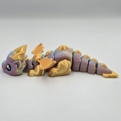 Articulated Baby Dragon – Rainbow & Gold  design by Layers In Green